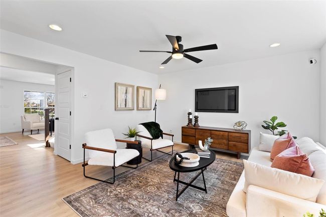 Living room featuring light hardwood / wood-style flooring and ceiling fan | Image 4