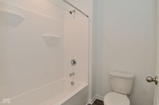 bathroom featuring shower / bath combination and wood finished floors | Image 44