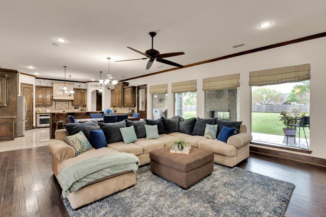 Living area featuring large windows with roman shades & recessed lighting | Image 6