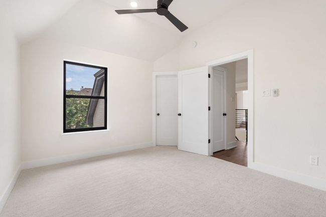 Each guest bedroom offers generous space and natural light, creating a welcoming environment for family or visitors. | Image 22