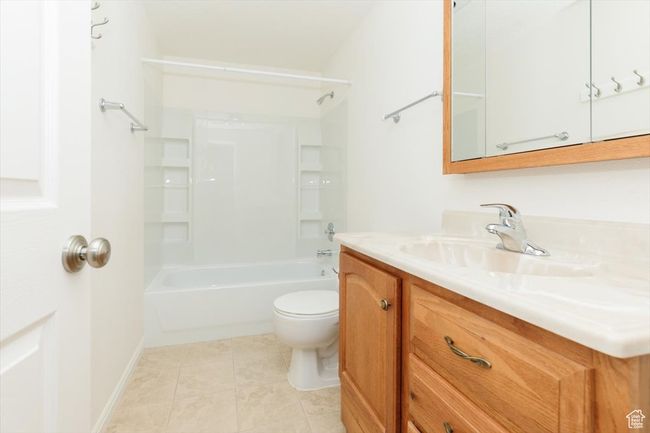 Full bath with vanity, shower / tub combination, and tile patterned floors | Image 54