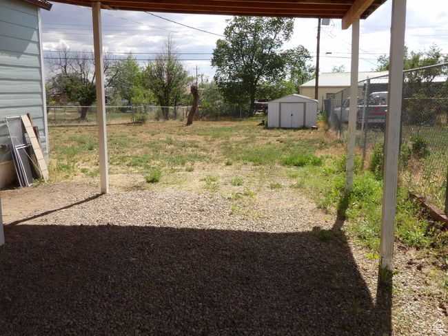 View of yard with a storage shed. | Image 4