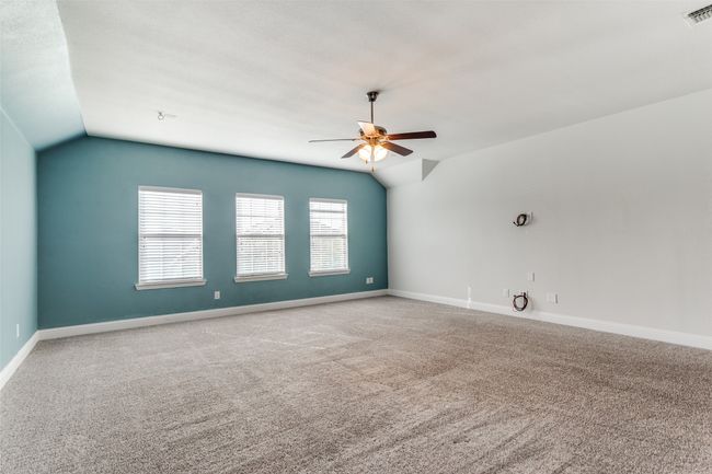 Unfurnished room with ceiling fan, carpet floors, and lofted ceiling | Image 17