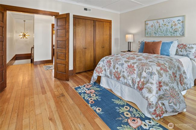 Elegant double doors open to the spacious primary bedroom. | Image 21