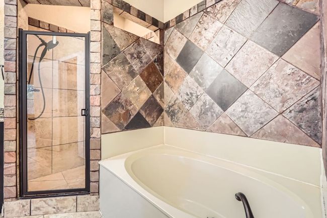 Full bathroom with a garden tub and a stall shower | Image 11