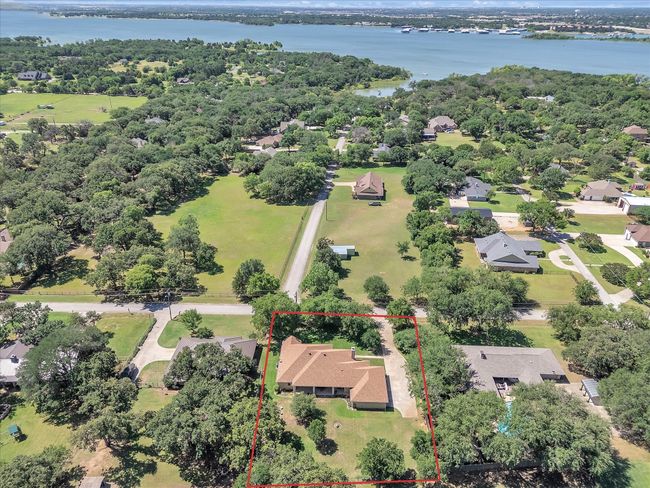 Aerial perspective of suburban area with a nearby body of water and property boundaries highlighted | Image 40