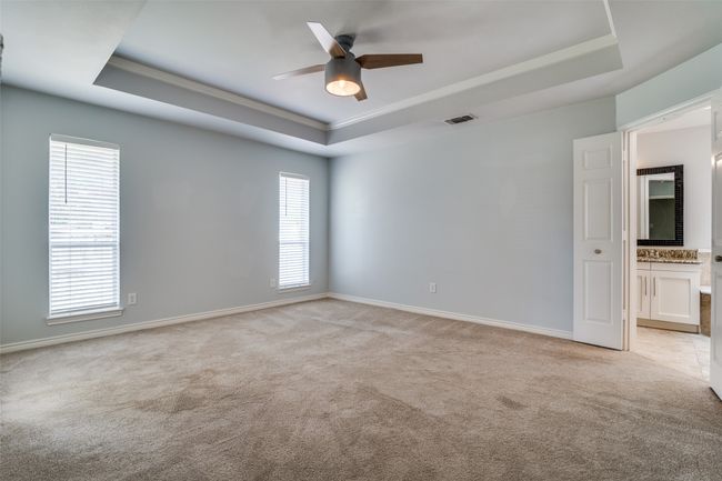 Primary bedroom with French doors to ensuite bath. | Image 17