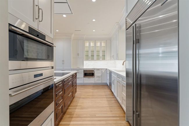 Wolf and SubZero appliances, Quartz counter tops and solid wood floors. | Image 7