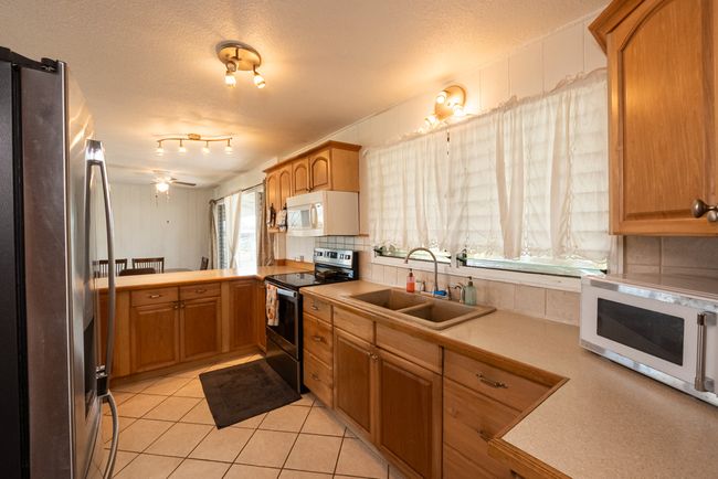 No shortage of light, windows, cabinets and counter space in the open-concept kitchen @ 007 Kaapuni Loop in Hilo. | Image 7