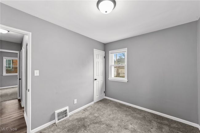 Bedroom featuring baseboards, visible vents, and carpet flooring | Image 14