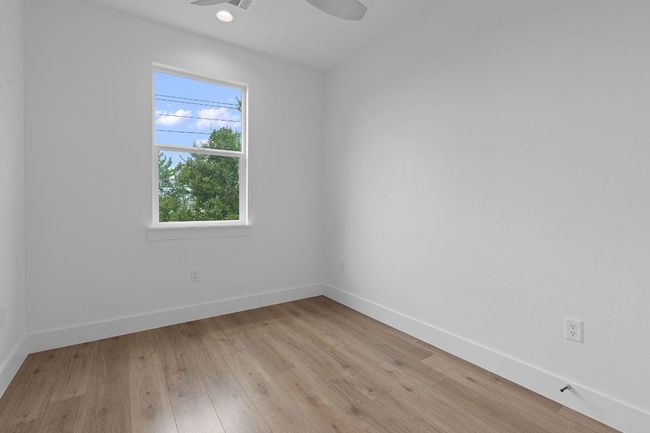 Spare room with light wood finished floors, baseboards, recessed lighting, and a ceiling fan | Image 15