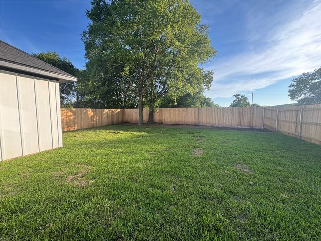 View of fenced backyard | Image 24