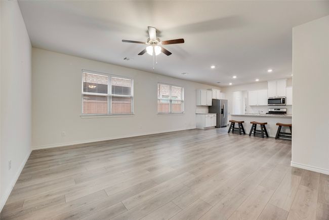 Unfurnished living room with ceiling fan, recessed lighting, light wood finished floors, and baseboards | Image 10