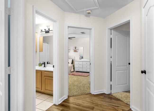 Corridor with attic access and light wood-style flooring | Image 21