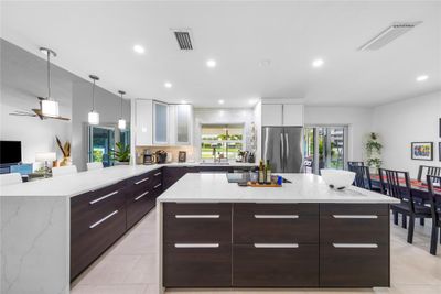 Gourmet kitchen with 2 waterfall countertops | Image 3