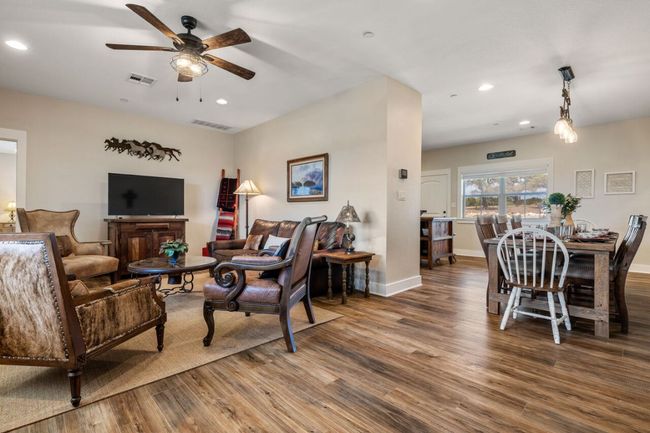 Living area with a ceiling fan, wood finished floors, recessed lighting, and baseboards | Image 30