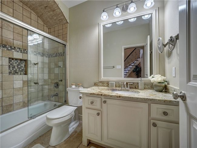 Second master suite bath features barrel ceiling and custom sliding glass doors. | Image 18