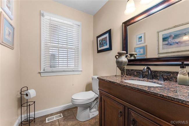 Half bathroom with tile patterned floors, visible vents, toilet, baseboards, and​​‌​​​​‌​​‌‌​‌‌​​​‌‌​​‌‌​‌​​​​​‌ vanity | Image 5