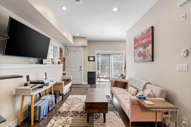 Living room with baseboards, wood finished floors, and recessed lighting | Image 6