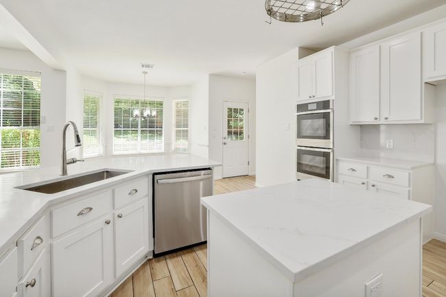 Gourmet Kitchen with Quartz Countertops and Stainless Steel Appliances and Island | Image 13