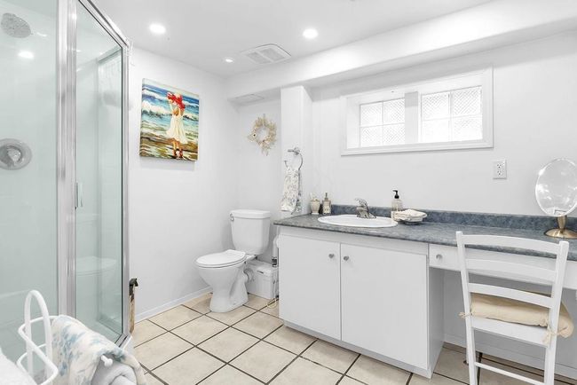 Full bathroom featuring vanity, a stall shower, tile patterned flooring, toilet, and visible vents | Image 18