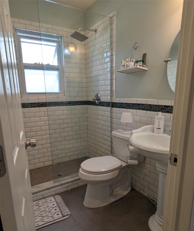 Full bathroom with a stall shower on the main level | Image 15