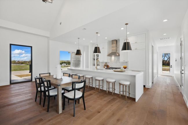 Dining room with baseboards, visible vents, wood finished floors, and recessed lighting | Image 5