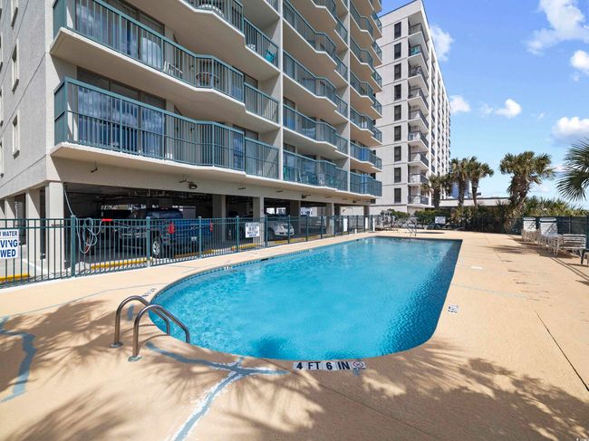 Community pool featuring fence | Image 30