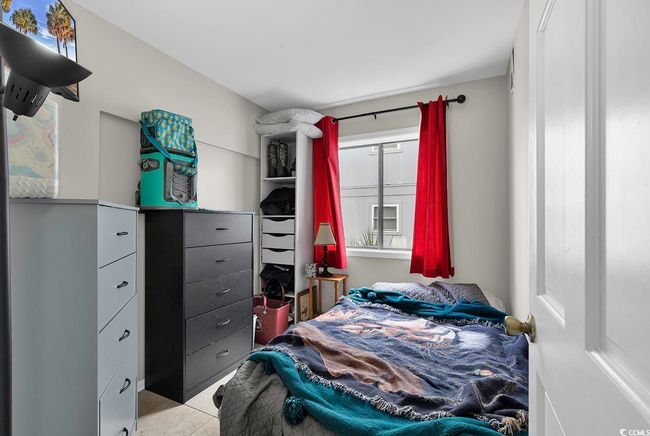 Bedroom with light tile patterned floors | Image 18