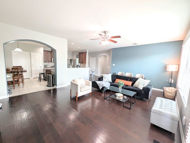 Living room with ceiling fan, arched walkways, wood finished floors, and recessed lighting | Image 19