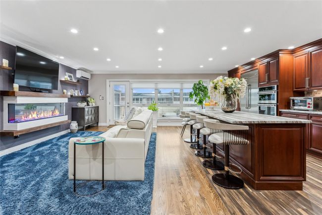 Living room with ornamental molding, hardwood / wood-style floors, and a wall mounted AC | Image 4