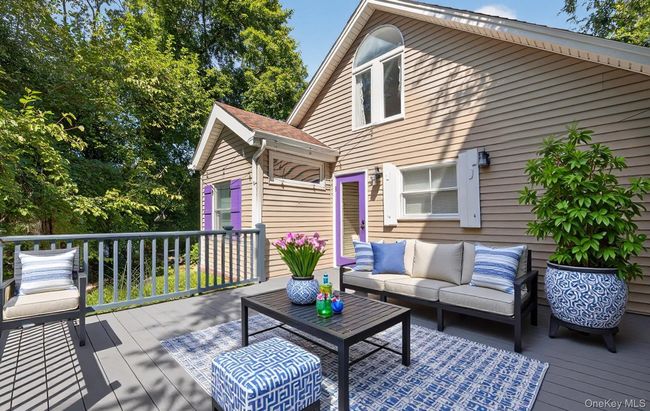 Wooden deck with an outdoor hangout area | Image 18