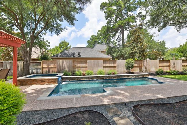 Recent modern style pool with hot tub. Stoneway walkway with drainage rocks for ease in maintaining. | Image 35