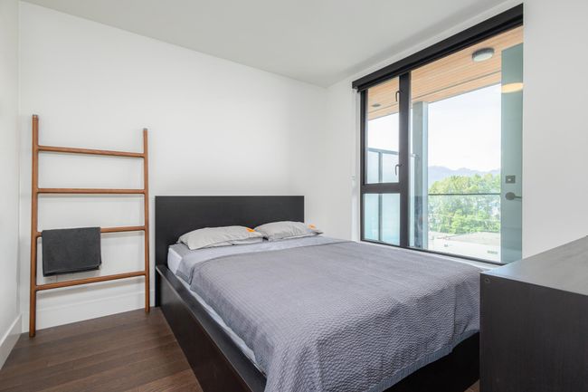 Bedroom with dark wood-type flooring and access to outside | Image 17