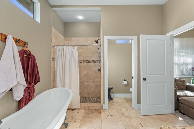 Full bathroom featuring a freestanding bath, toilet, baseboards, and a shower stall | Image 17