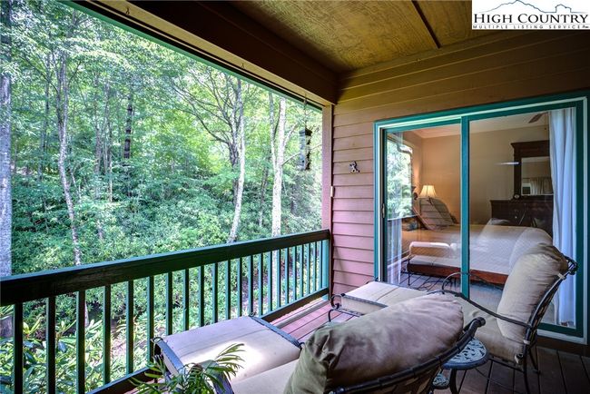 Covered porch overlooking a rushing creek. | Image 25