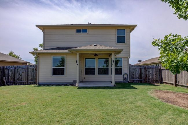 Back of property featuring ceiling fan and a patio. | Image 33