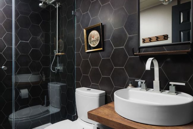 Bathroom with a sink, tile walls, a tile shower, and toilet | Image 18