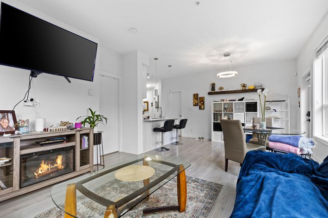 Living room with wood finished floors and a glass covered fireplace | Image 35