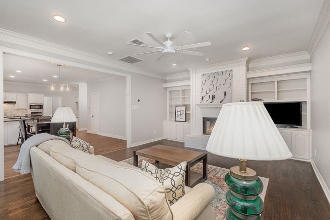 Den with gas burning fireplace, built-in cabinets and shelves | Image 12