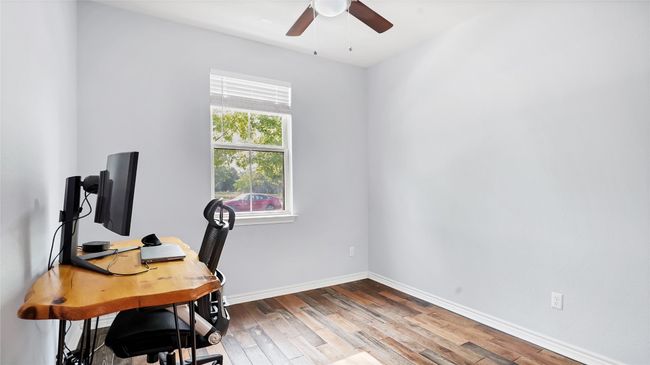 Office space with ceiling fan, baseboards, and wood finished floors | Image 8