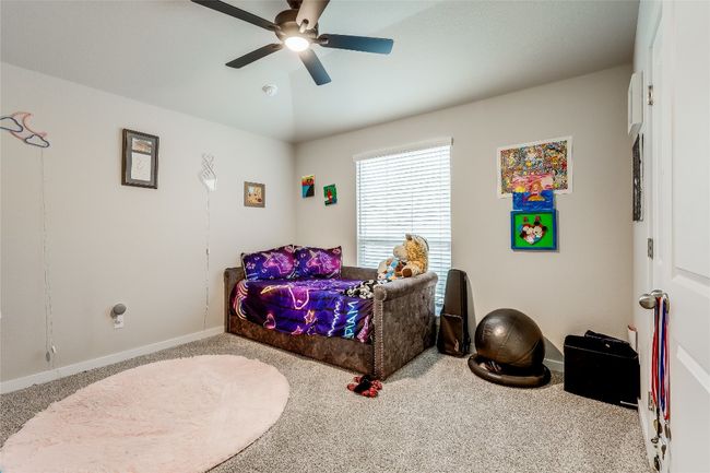 Bedroom with carpet floors, baseboards, and ceiling fan | Image 26