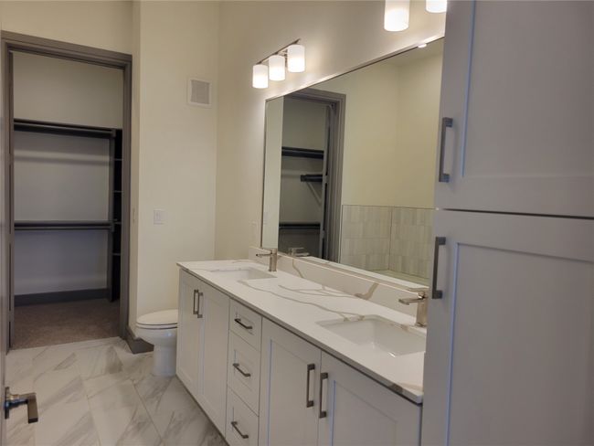 Full bathroom featuring visible vents, a sink, marble finish floor, and toilet | Image 11