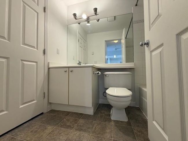 Full bathroom with a bath, vanity, toilet, walk in shower, and tile patterned floors | Image 10