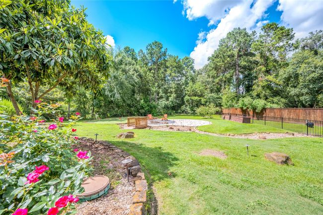 Enjoy a serene backyard escape directly from the kitchen patio. | Image 38