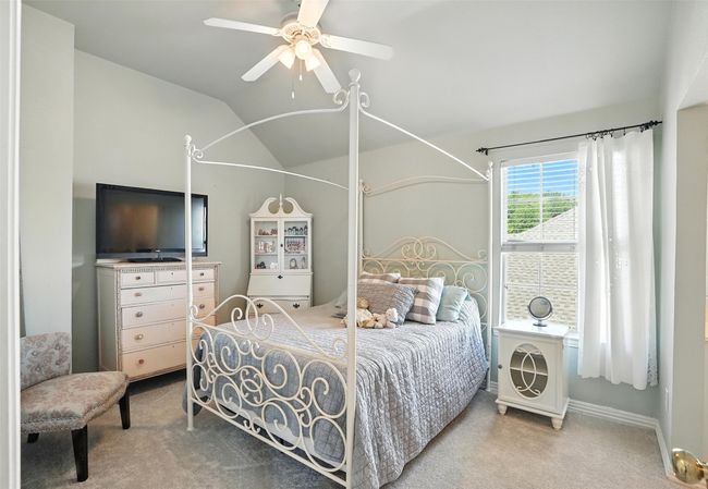 Carpeted bedroom featuring vaulted ceiling and ceiling fan | Image 26