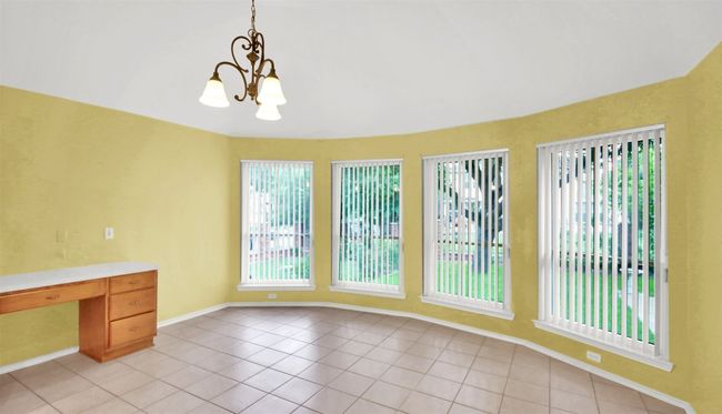 Breakfast area featuring light tile patterned floors and a chandelier | Image 19