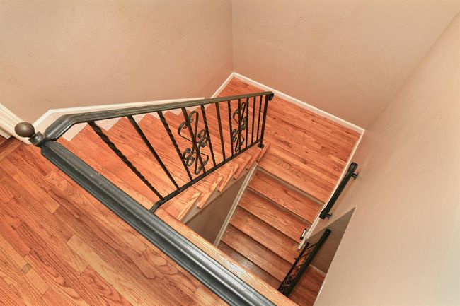 Stairs with baseboards and wood finished floors | Image 21