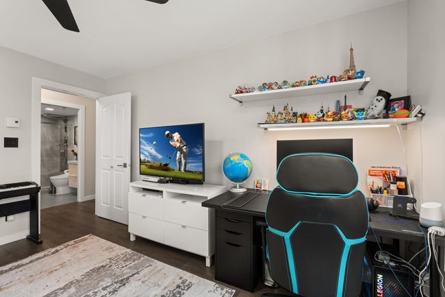 Office area featuring dark wood-style floors and a ceiling fan | Image 26
