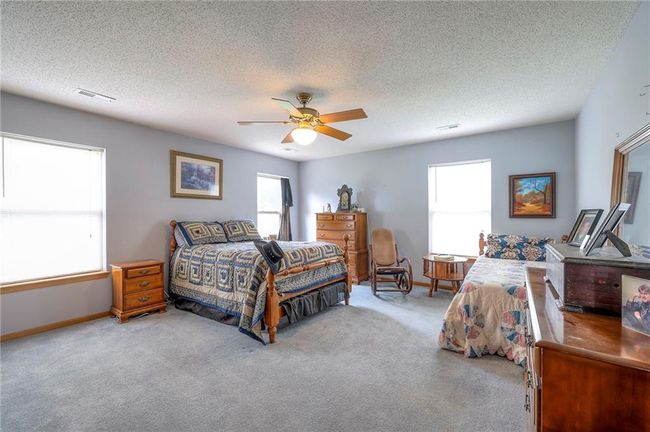 Bedroom with carpet, a ceiling fan, and a textured ceiling | Image 29